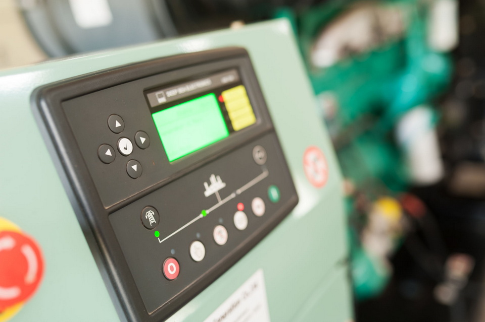 Close-up of a generator control panel with warning lights