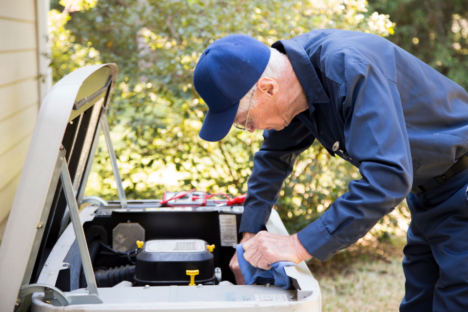 A user checking the oil on a generator